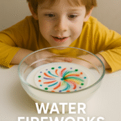 Young boy watching colourful dye burst in expired milk during water fireworks science experiment