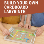 Two children building a cardboard marble maze using colourful straws