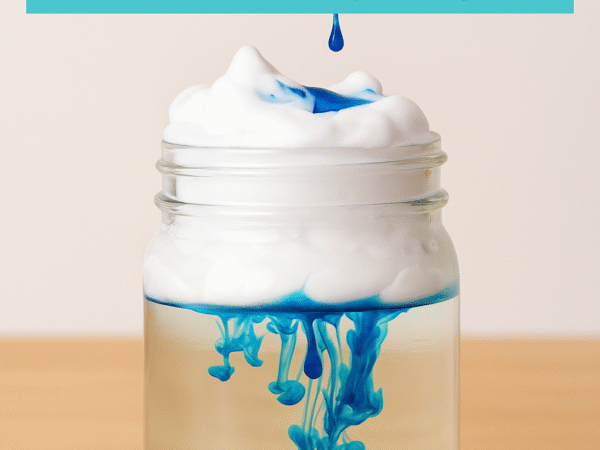 Rain in a Jar science experiment showing blue colored water dripping through shaving cream into a clear jar of water